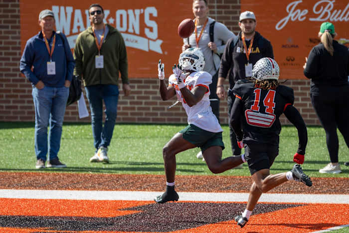 Jan 31, 2023; Mobile, AL, USA; National wide receiver Jayden Reed of Michigan State (1) makes a catch in the end zone ahead of National defensive back Ronnie Hickman of Ohio State (14) during the first day of Senior Bowl week at Hancock Whitney Stadium in Mobile.